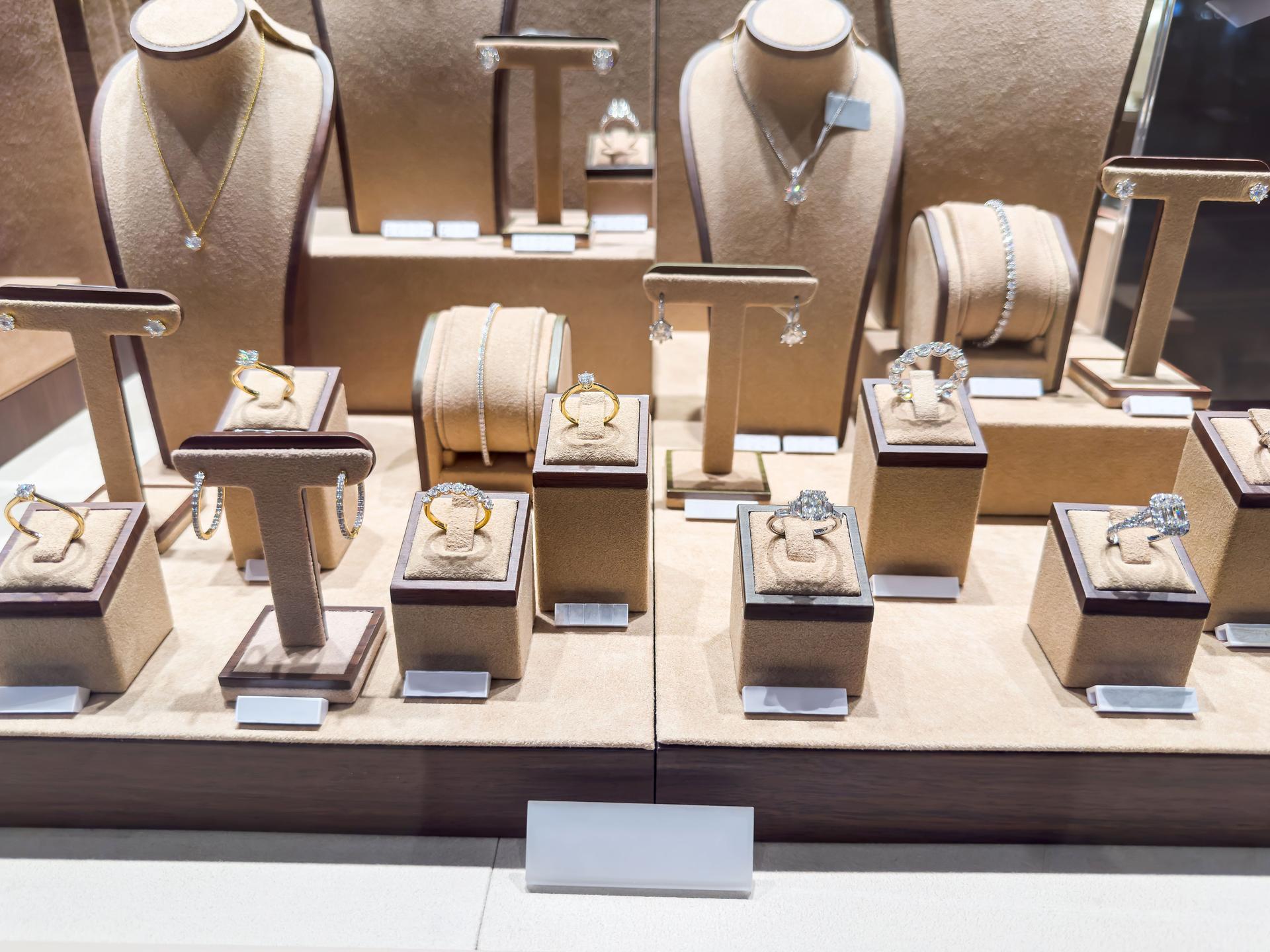 Showcase with luxury golden diamond necklaces, bracelets and earrings in a jewellery shop