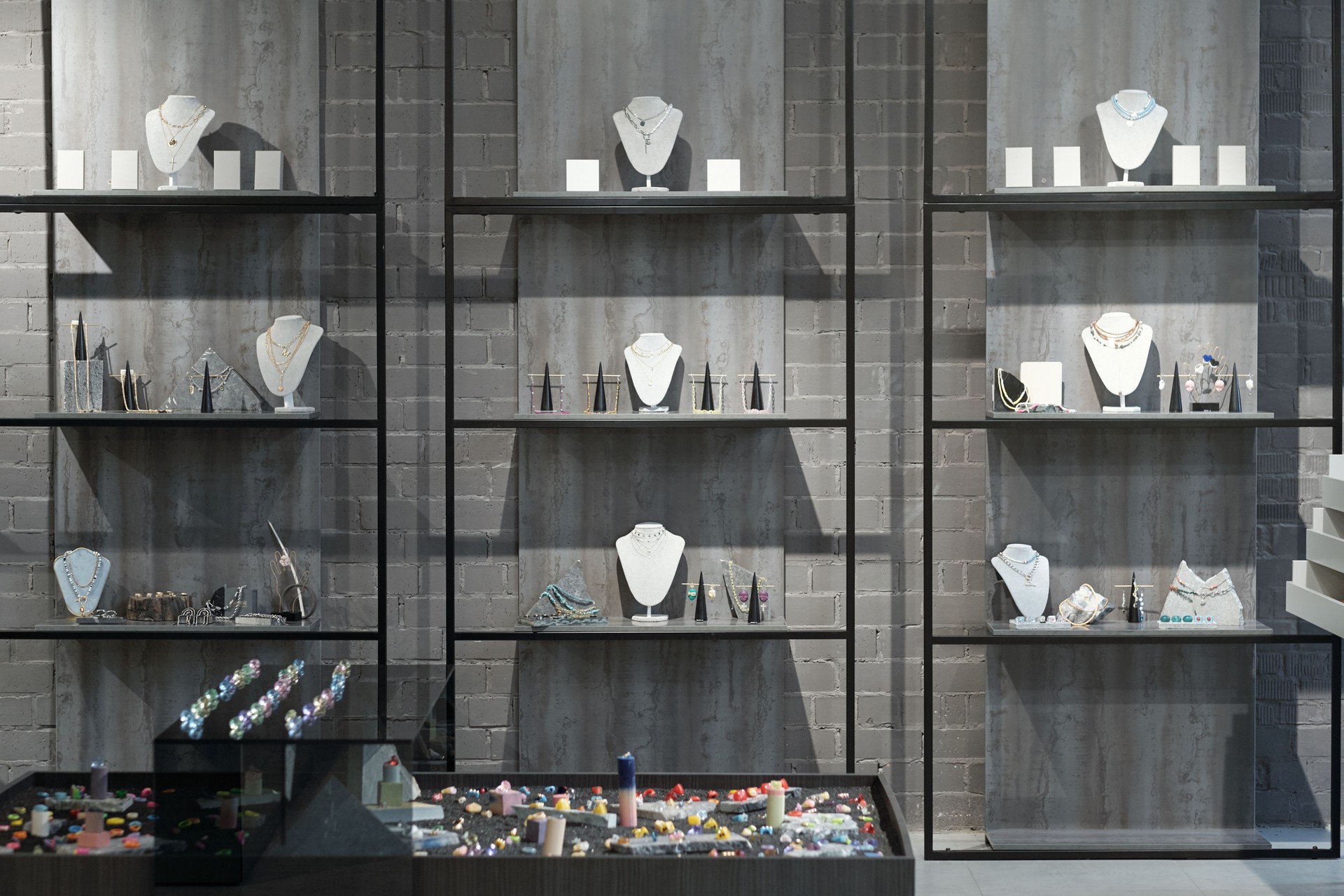 Part of interior of luxury jewelry store with necklaces on displays
